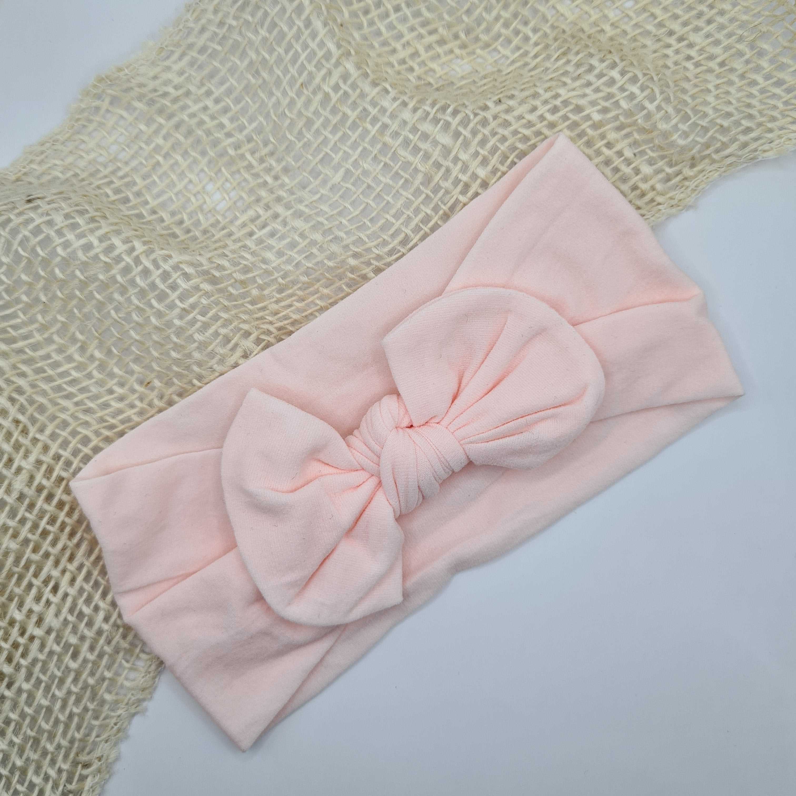 Zachte nylon haarband met strik licht roze